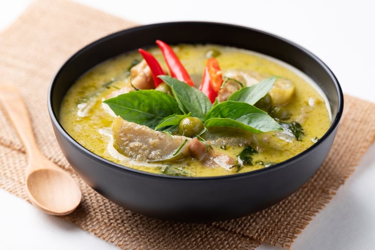 Thai green curry chicken in black bowl